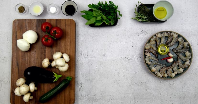 A cutting board with fresh vegetables and simple ingredients